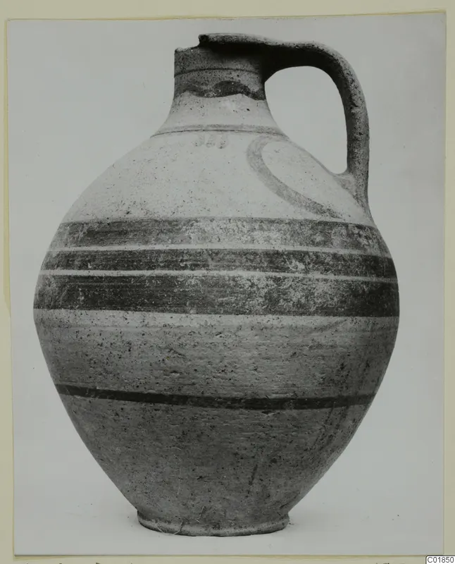 White Painted VI jug with a single loop handle and dark painted bands, shown against a plain background