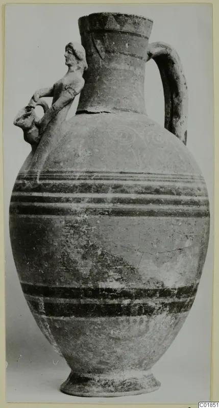Jug with a modelled human figure on its shoulder, a strap handle and horizontal painted bands on the body