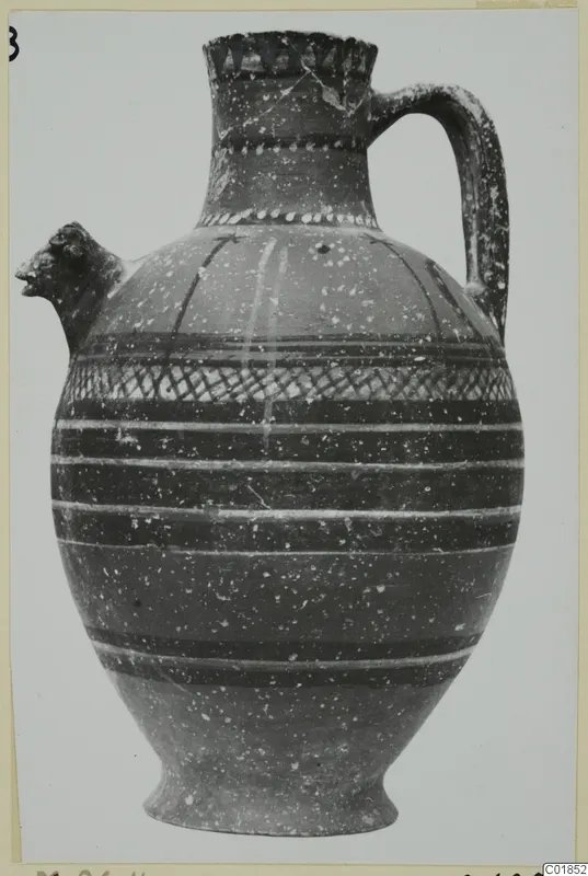 Jug with a head-shaped spout, a loop handle and painted bands, including a cross-hatched band on the body, from Marion