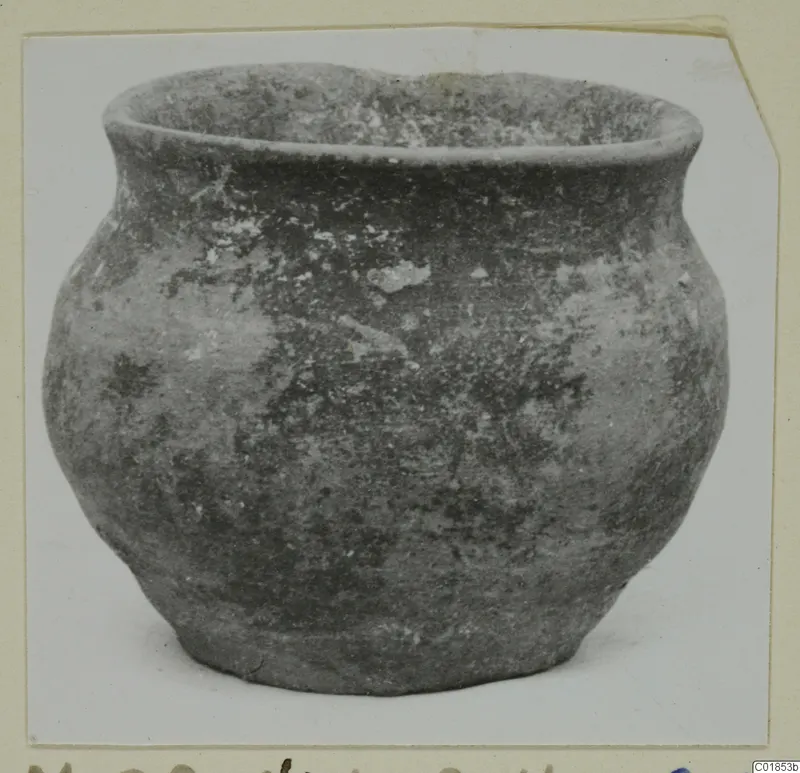 Pottery vessel from Marion with a rounded body and short flaring rim, shown on a mounted card