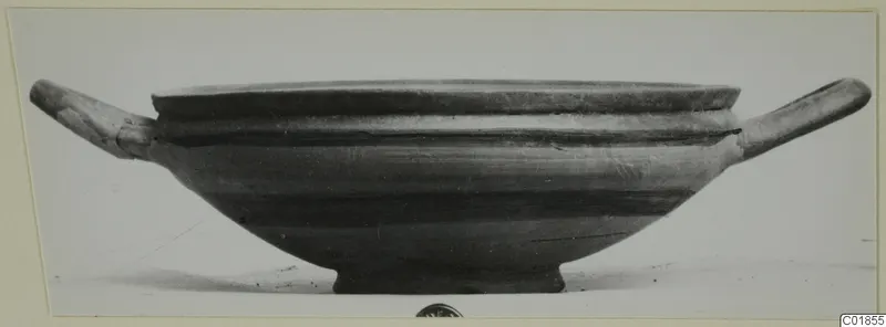 Shallow pottery bowl with two horizontal handles and a ring foot, seen from the side