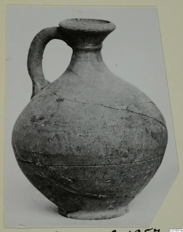 Pottery jug from Marion with a single loop handle and cracked body