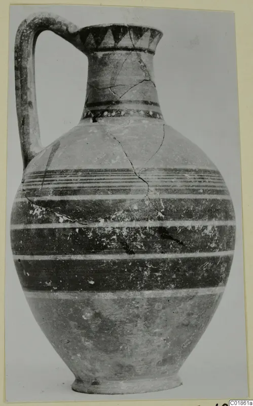 Bichrome-Red pottery jug with a strap handle and horizontal painted bands