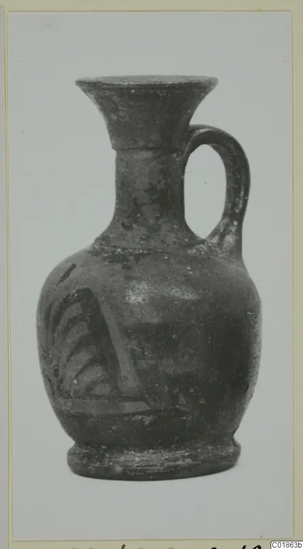 Small jug with a flared mouth and strap handle, with painted strokes on its body, from Marion.