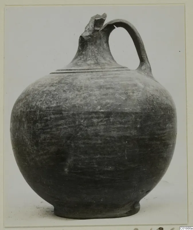 Globular jug from Marion with a strap handle and broken spout
