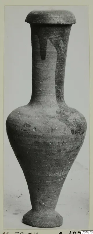 Cypro-Hell.I. pottery: tall vessel with a narrow neck, flat disc-shaped top and ring foot, shown against a plain background