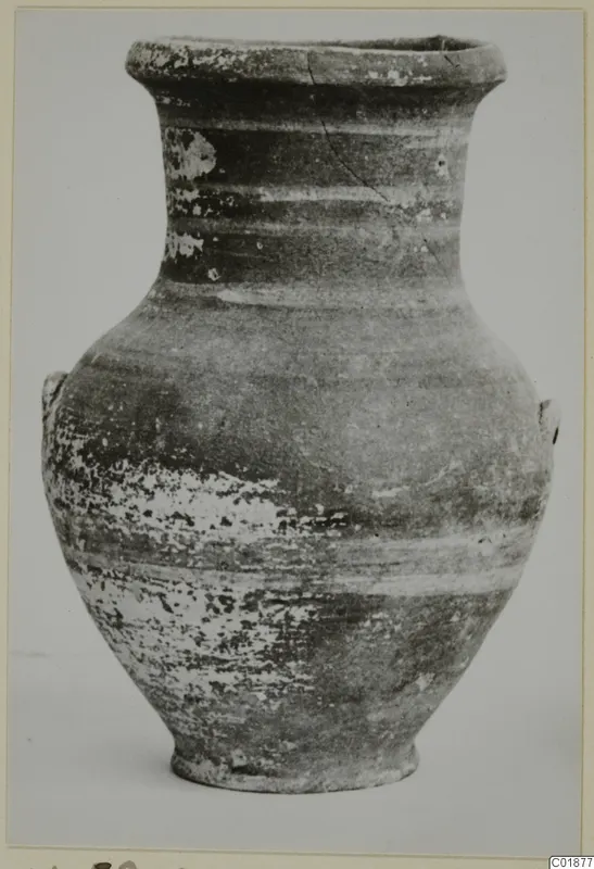 Pottery amphora with a flared rim, two small handles and a ring base, photographed alone