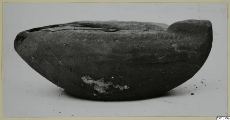 Terracotta lamp from Marion, tombs 31–45, shown from the side on a pale surface