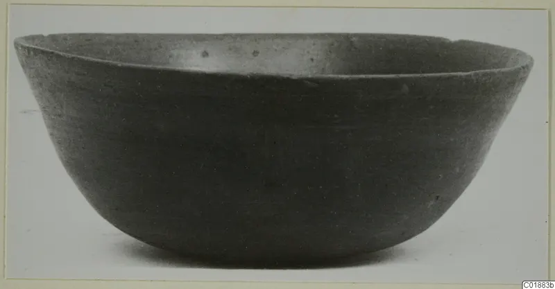 Pottery Black Slip I-VI bowl, a wide open bowl with dark, smooth surface seen from the side