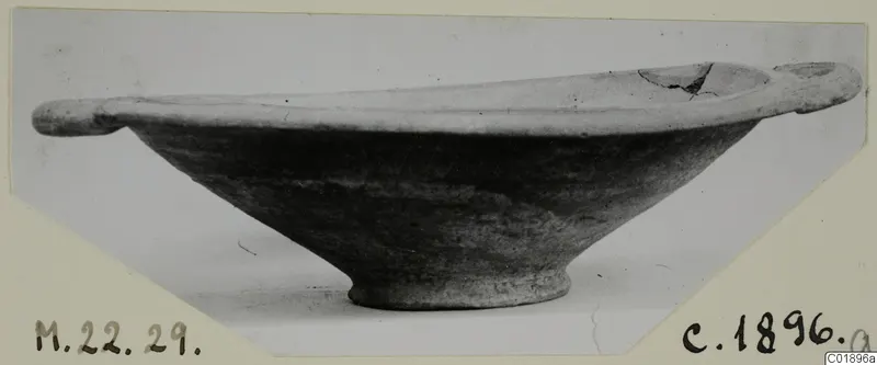 Pottery bowl with two small horizontal handles and a ring foot, from Marion, photographed on a mounted card
