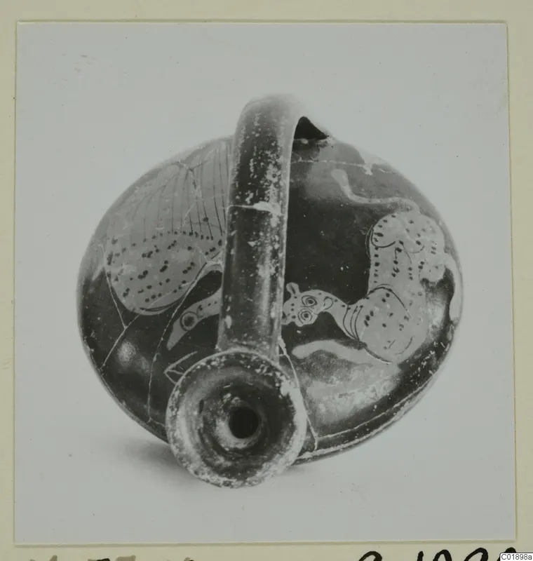 Red figured pottery vessel with a tall strap handle and animal figures, shown from above with the mouth toward the camera