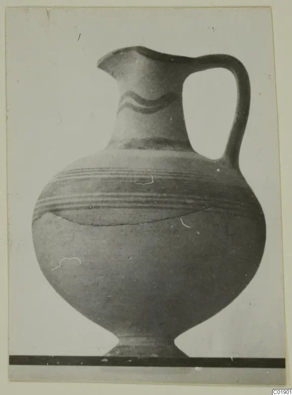 White Painted I jug with a single loop handle, a wavy band on the neck and horizontal bands on the body.