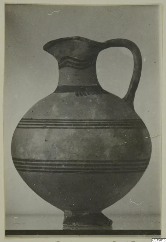 White Painted I jug from Lapithos, photographed against a plain grey background