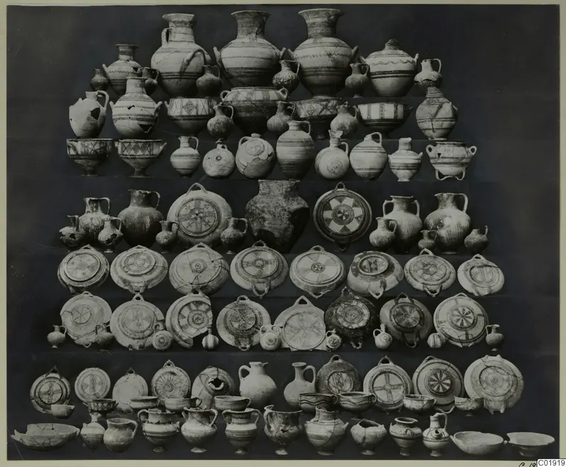 Group of pottery vessels from Idalion Tomb 3, jugs, bowls and round dishes arranged in tiered rows