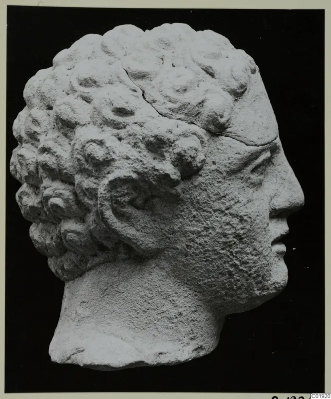 Head of a sculpture in pale stone from Mersinaki, shown in profile facing right, with rows of curled hair