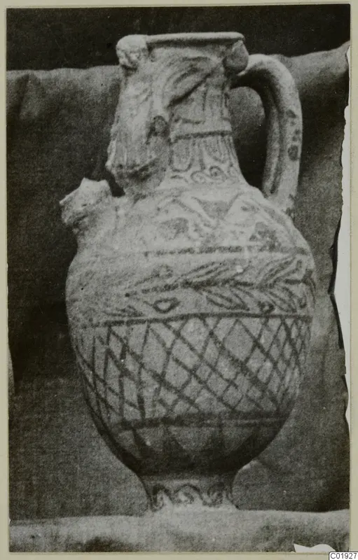 Painted pottery vessel with a strap handle and a modelled head at the neck, Pottery Black-on-Red III_V - V_VII