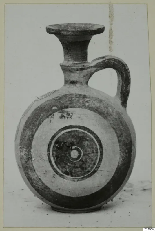 Bichrome pottery juglet with a flared neck, loop handle and concentric circles on its body