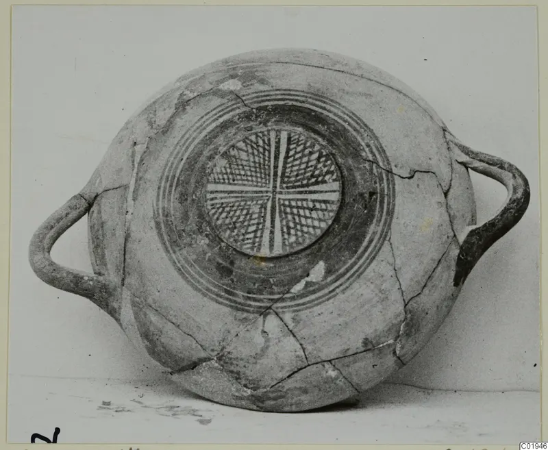 Pottery White Painted I bowl with two side handles and a cross-hatched central medallion surrounded by concentric rings