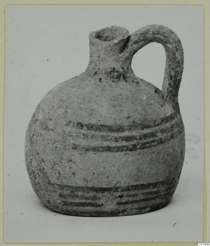 White Painted II jug from Lapithos with a single loop handle and dark painted bands on the body