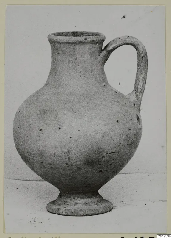 Pottery Plain White I-III jug with a flared rim, rounded body, ring foot and single loop handle