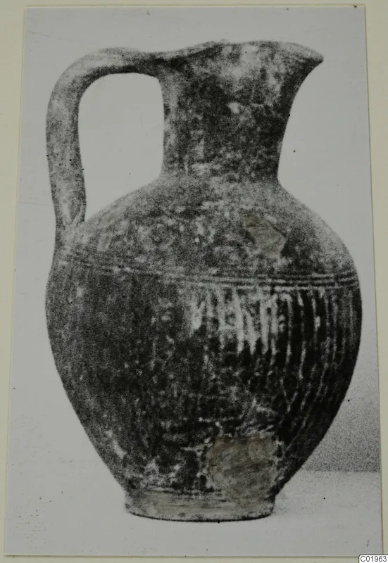 Black slip jug with a strap handle and vertically ribbed lower body, from Lapithos