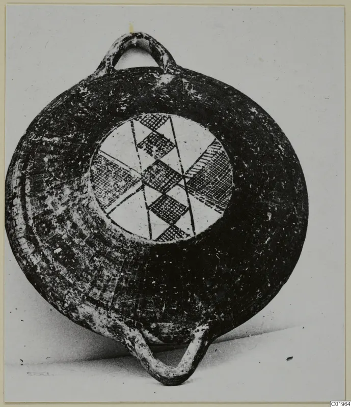 Black slip painted pottery vessel with two loop handles and a hatched geometric pattern in its central panel