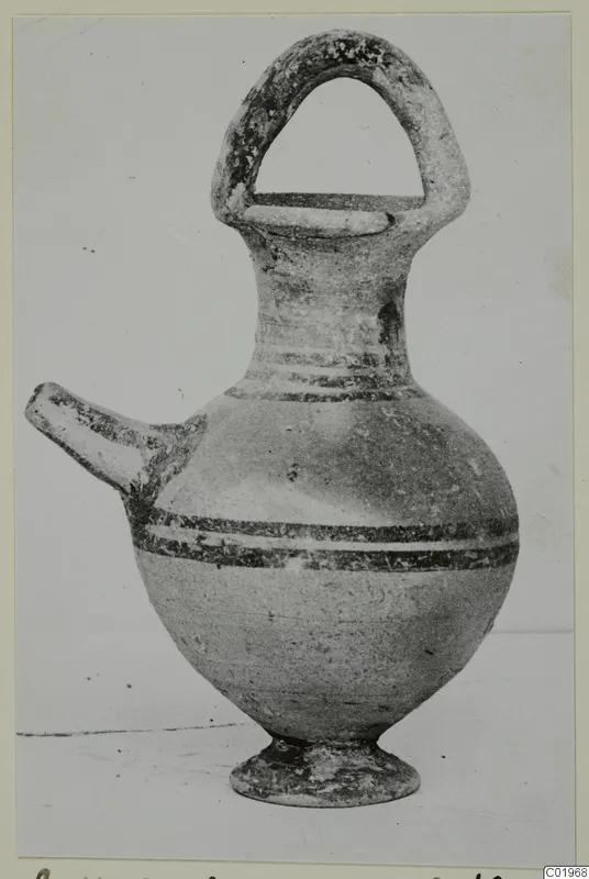 Pottery Bichrome II spouted vessel with a strap handle and painted bands, from the Kastros tombs at Lapithos