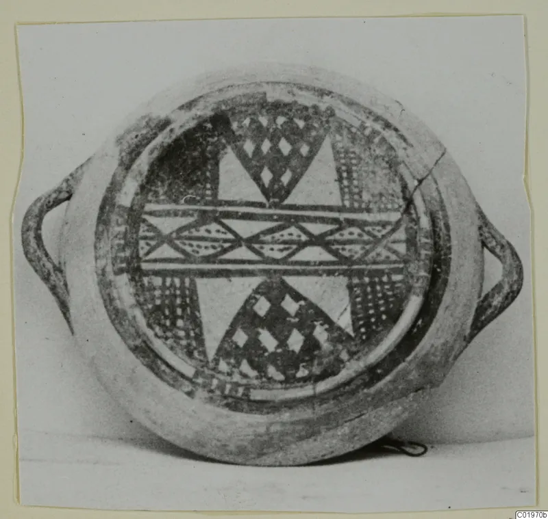 Round painted vessel with two loop handles, seen from above, decorated with dark geometric bands and diamond motifs