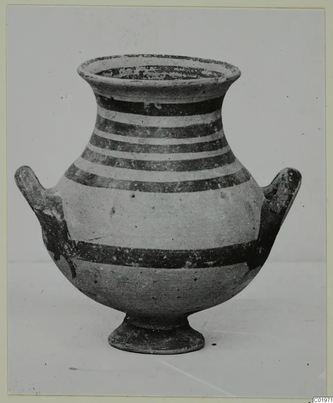 White Painted I amphora with dark horizontal bands, two side handles and a low ring foot, seen from the side.