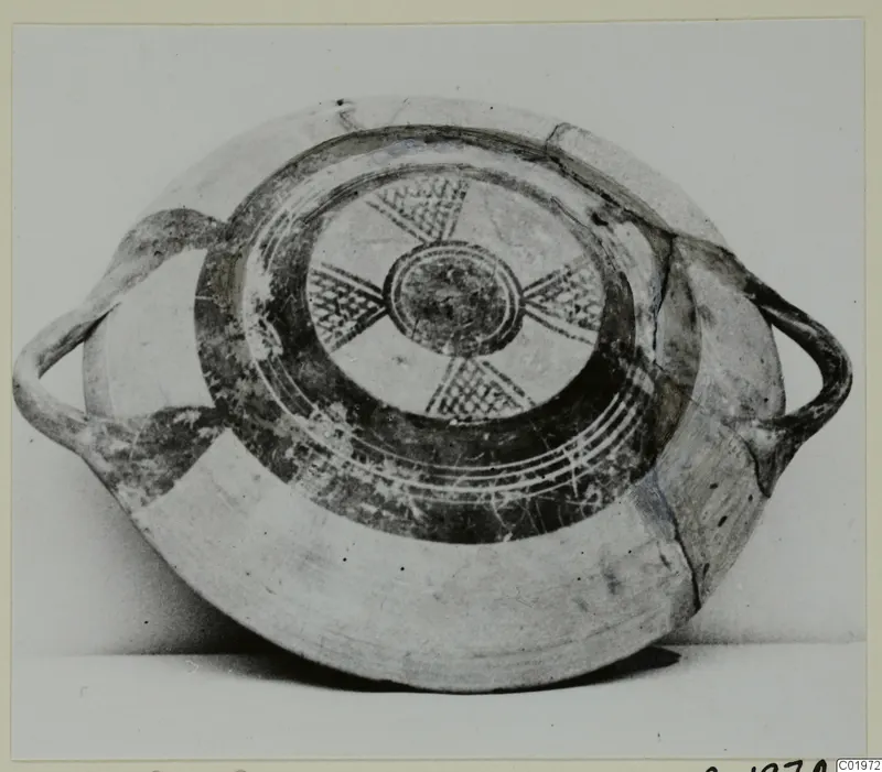 White Painted I bowl with two handles and painted interior of radiating cross-hatched bands around a central circle