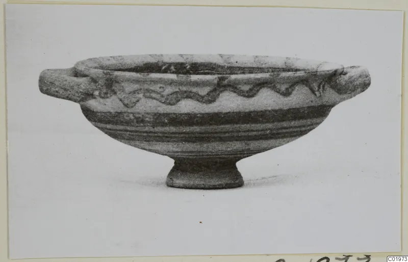 White Painted I bowl from Lapithos with two horizontal handles, a ring foot and a wavy painted band around the body.
