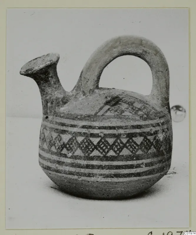 White Painted I jug with a spout and strap handle, decorated with painted bands and a lattice pattern