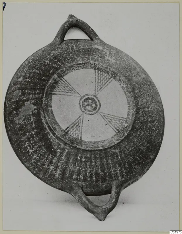 Black Slip Painted bowl with two loop handles and a radiating hatched pattern on its central disc, from Lapithos.