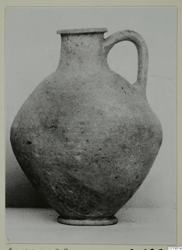 Plain pottery jug with a single loop handle, a flared rim and a rounded body on a ring foot.