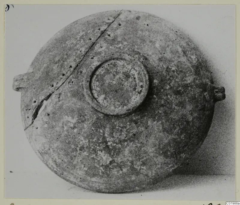 Foreign Red Slip vessel seen from above, with a central circular boss and two small handles on opposite sides