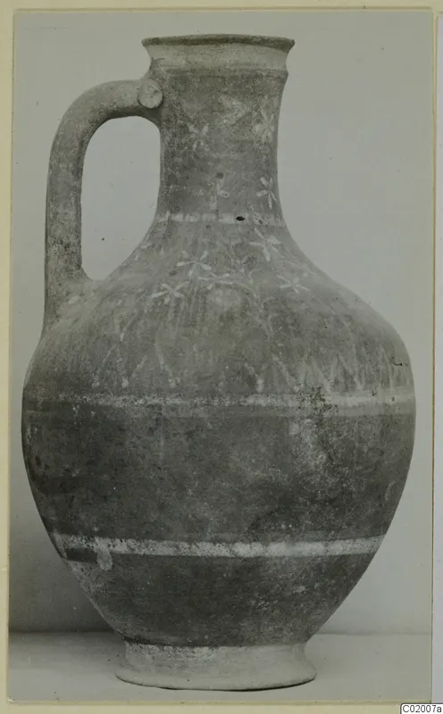 Pottery jug with a loop handle, white painted bands and floral motifs on the neck and shoulder, from Vouni