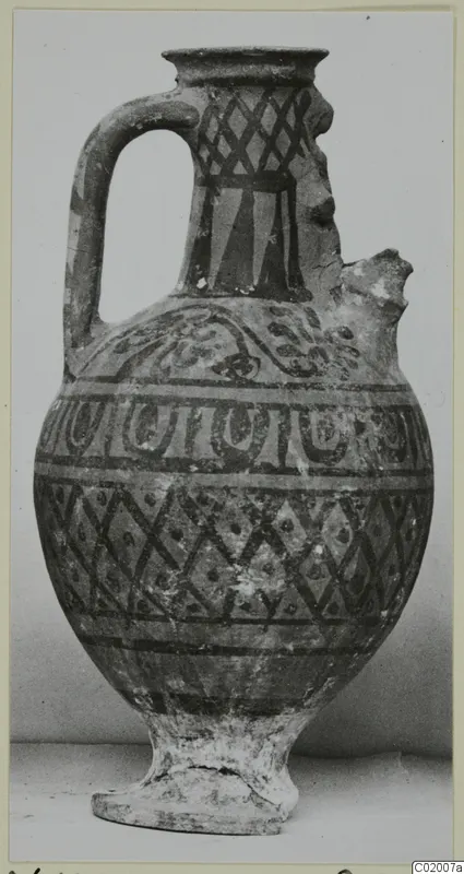 Pottery White Painted VI jug with a single loop handle, broken spout and dark painted bands and lattice on pale clay