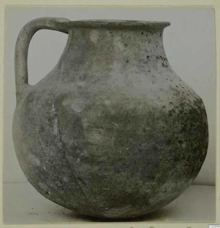 Coarse ware jug with a single loop handle, rounded body and flaring rim, from Vouni