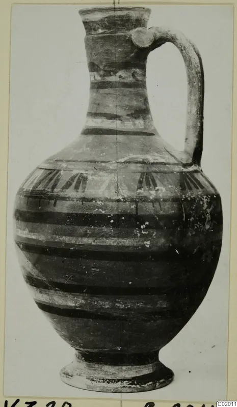 Jug from Vouni with a strap handle, a flared neck and dark painted bands on the body