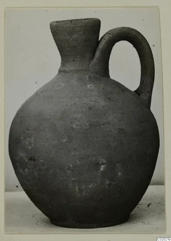 Jug of Plain White VII ware from Vouni, with a single loop handle and narrow flaring neck