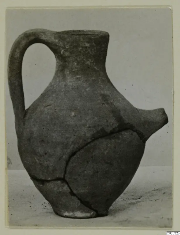 Pottery Plain White VII, a feeding bottle with a single handle and a spout, with a repaired crack.