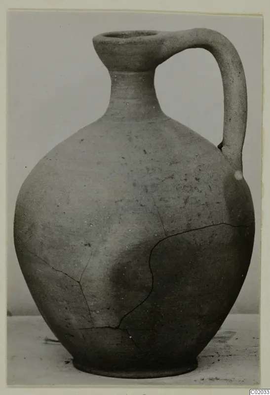 Pottery Plain White VI jug with a single handle and a cracked body