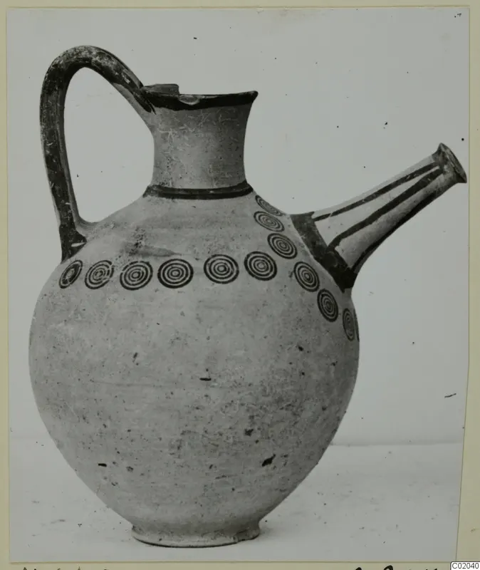 Pottery White Painted III-1 jug with a side spout and a row of concentric circles around the shoulder