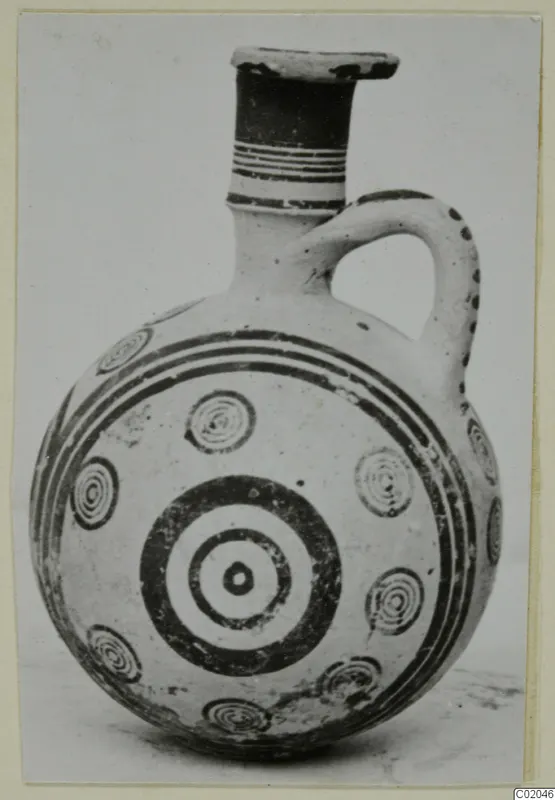 Jug with a round body, banded neck and concentric circle motifs in dark paint, from Marion, Pottery Black-on-Red I-III