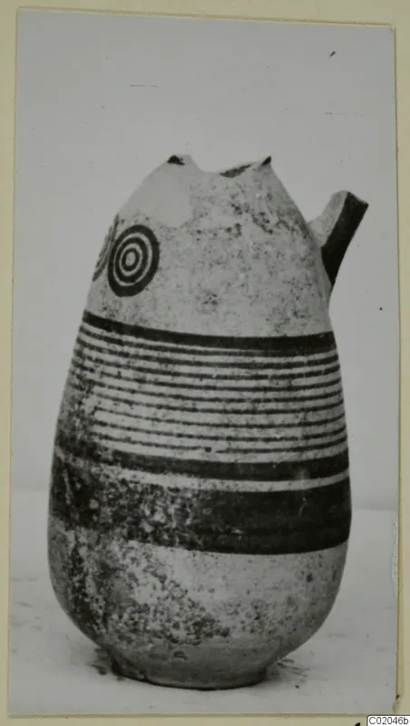 Pottery Black-on-Red I-III, a jug with a broken neck and a short side spout