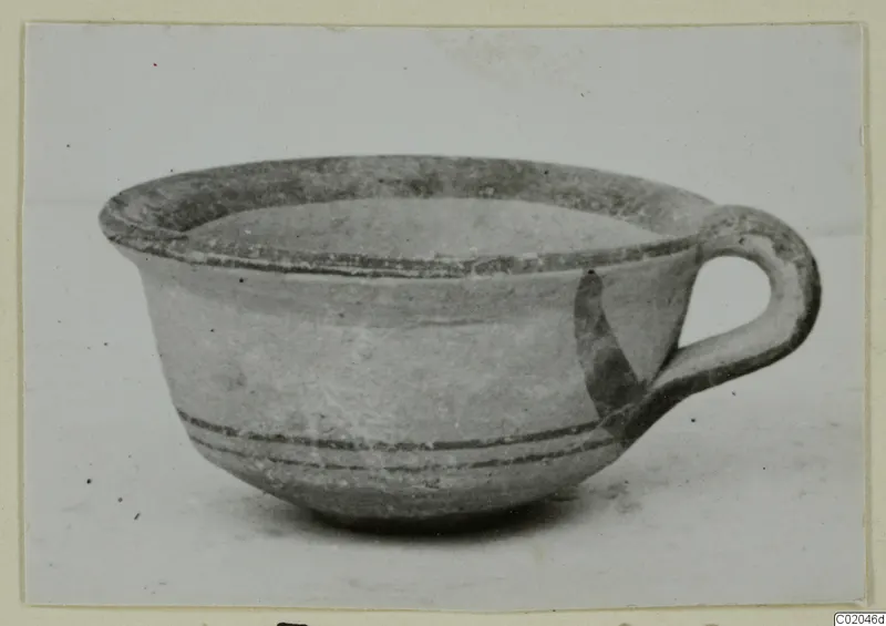 Pottery White Painted IV cup with a loop handle, from Marion