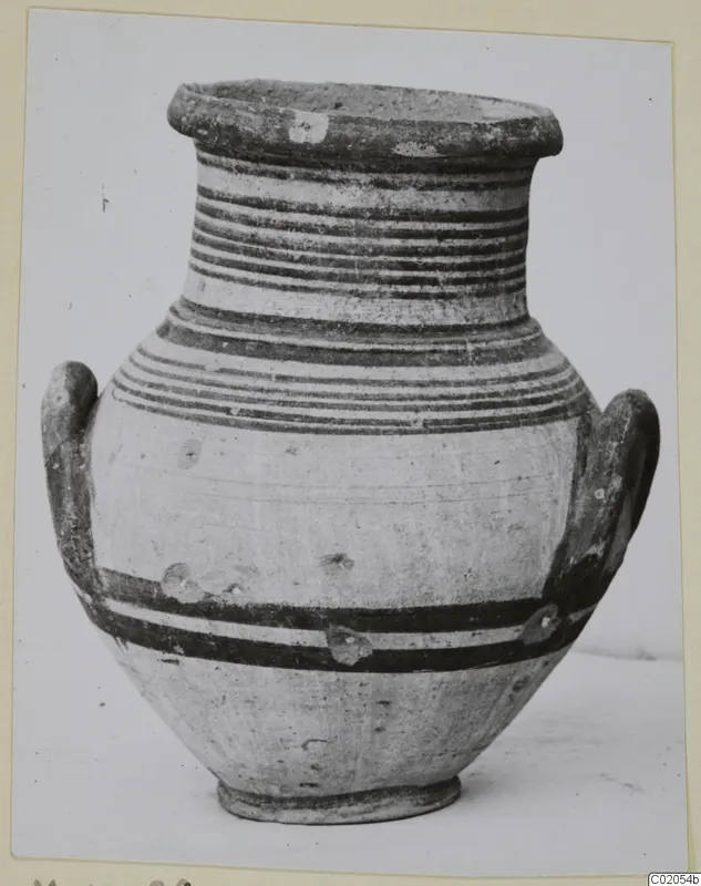 Pottery White Painted IV amphora with two loop handles and horizontal dark painted bands on a pale surface.