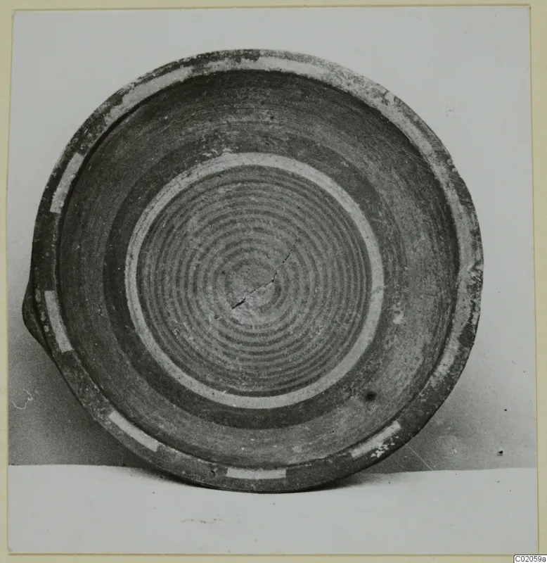 Plate of Bichrome-Red pottery seen from above, with concentric dark rings in its interior and pale bands near the rim.