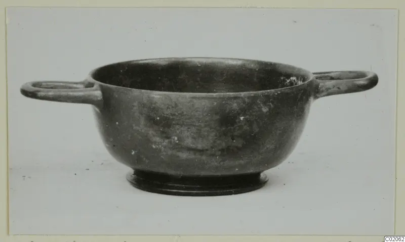 Two-handled black glazed bowl with a ring foot, from Marion, shown in side view