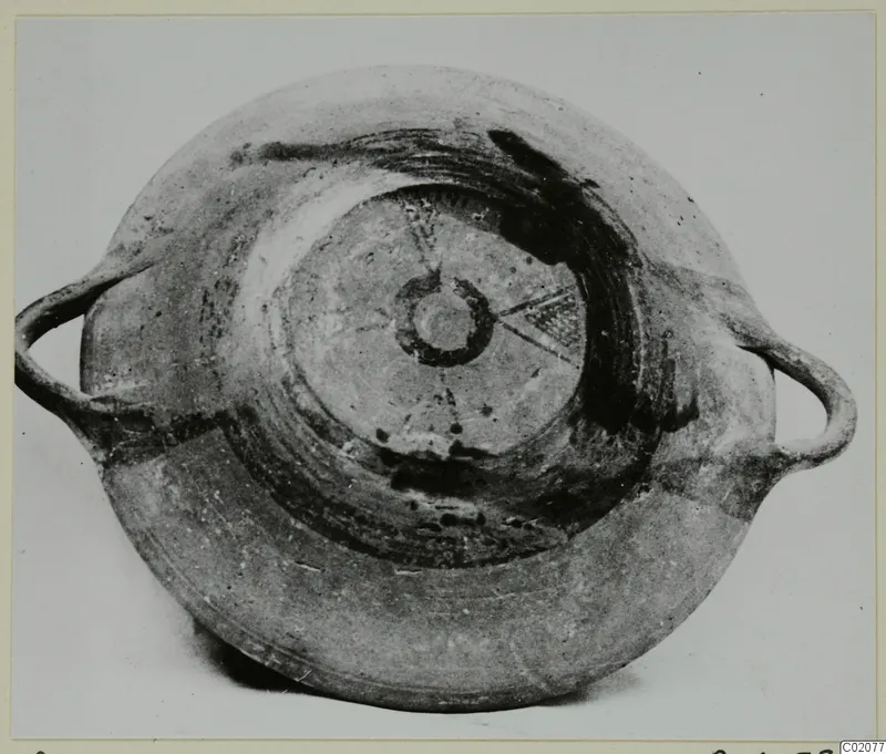White Painted I bowl from Lapithos, photographed from above, with two loop handles and dark painted bands inside.